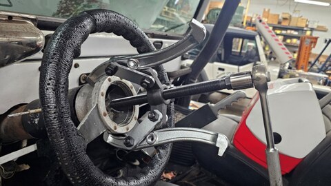 Bearing puller removing a non-standard steering wheel from the CJ-5 column